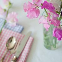 Table setting with Lathyrus - Sweet Peas in glass vase
