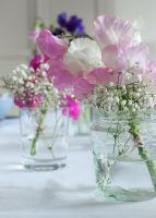Table with Lathyrus - Sweet Peas and Gypsophila - Babys Breath in glass jars