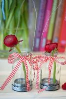 Ranunculus in glass vases with gingham ribbons