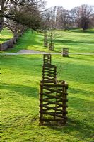 Plas Cdanant Gardens, Menai Bridge, Anglesey, Wales. April. Part of the Estate. Ornate tree protection