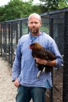 Patrick holding free range chicken - Growing Together Nursery