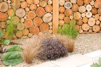 Timber wall created by pattern of logs and gravel bed. Carolyn R Hardern Garden Design 