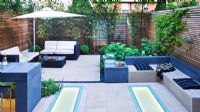 Modern garden with built in benches and dining area 
