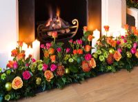 Christmas decorations around fireplace 
