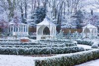 Formal town garden with gazebo covered in snow, Oxford, UK. 
