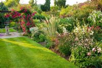 Sundial arbour and herbaceous border in summer - Meadow Farm, Worcestershire 