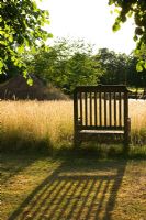 Meadow garden with wooden bench, Oxfordshire