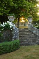 Curved stone steps with ornate urns, Cotswolds
