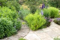 Paths made from concrete sleepers and cobbles with adjacent cottage borders 