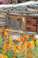 Insect hotel and old book built in to dry stone wall 