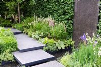 Polished concrete pads form stepping-stones across stream in 'The Lands End Across the Pond Garden' - Gold Medal Winner, RHS Chelsea Flower Show 2011