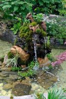 Water fall running from from Moss covered tree stump
