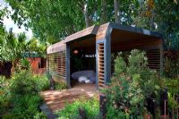 Contemporary wooden summerhouse and pebble shaped furniture in 'The Australian Garden presented by the Royal Botanic Gardens Melbourne' - Gold Medal Winner, RHS Chelsea Flower Show 2011 
