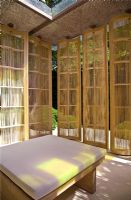 Japanese style screens surround upholstered bench in 'The Laurent-Perrier Garden by Luciano Giubbilei - Nature & Human Intervention' - Gold Medal Winner, RHS Chelsea Flower Show 2011