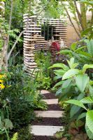 Concrete path and  tropical planting in 'The Bradstone Fusion Garden' - Silver Gilt Medal Winner, RHS Chelsea Flower Show 2011 
