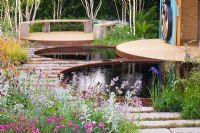 Circular pools to capture rainwater with patio beyond  - 'The Royal Bank of Canada with the RBC New Wild Garden' - Silver Gilt Medal Winner, RHS Chelsea Flower Show 2011 