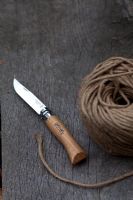Wooden garden handled knife with ball of string on bench