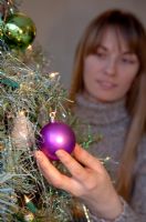 Woman decorating Christmas Tree