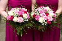 Bridesmaids holding wedding bouquets of pink and white roses