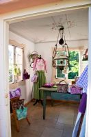 A typical Bavarian dress, the Dirndl, and handbag display in the traditional summer house with a glass and iron lamp - Handbag Garden, Freising, Germany 
 