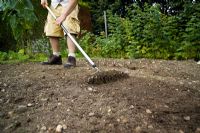 step by step, making a raised bed - raking and preparing soil