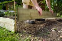 step by step, making a raised bed - placing planks