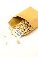 Climbing French bean 'Blue Lake' seeds falling out of a brown envelope with handwritten label.