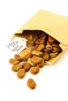 Seeds of Broad bean 'Aqua dulce' falling out of a brown paper envelope with handwritten label