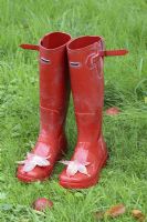 Red wellington boots with Autumn leaves on the toes in October