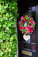 Summer wreath by Susan Wright with 'home Sweet Home' heart on classic front door 