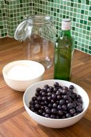 Making home-made Sloe Gin - materials and equipment laid out on kitchen worktop 