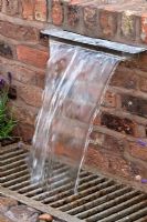 Water feature built in to brick wall 