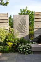 Concrete wall and wooden fences in modern garden 