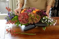 Woman making floral arrangement