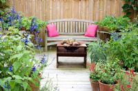 Enclosed decked area with seating, fire basket and collection of Salvias in containers - Woodpeckers, NGS, Essex
