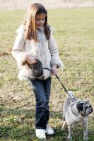 Girl on a walk with her pet Pug