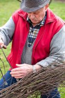 Making a Birch broom - man preparing birch branches