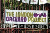 London Orchard Project sign displayed on the entrance gates to Camley Street Natural Park for apple day, King's Cross, London Borough of Camden, London, UK
