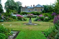 The Sickle Beds, in the formal garden to the west of the house, with central urn and beds full of Phlox, Lythrums, Crinums and other herbaceous perennials - Old Rectory, Pulham, Dorset