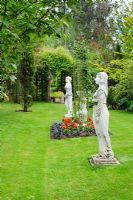 Classical statues in lawn - The Rowans, Threapwood, Cheshire.