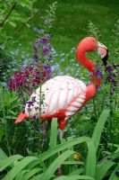 Plastic flamingo ornament in border with purple Verbascum - The Rowans, Threapwood, Cheshire 