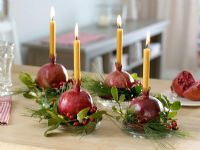 Candle holders made from pomegranates and mistletoe