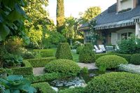 Formal style Mediterranean garden with clipped hedges and pond - Madrid, Spain 