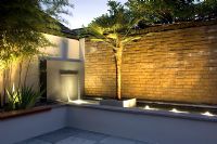 Small urban garden with water feature and uplighters, London