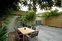 Small urban garden with seating area and water feature, London