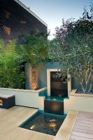 Modern water feature with lighting in urban courtyard garden - London, UK