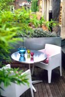 Contemporary roof garden with patio furniture, bamboo screen and metal trough container -Islington, London, England