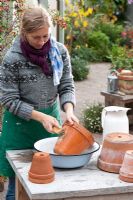 Woman washing terracotta pots