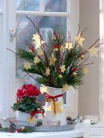 Christmas bouquet of Cornus, Pinus and Cyclamen with stars cut out of beeswax
