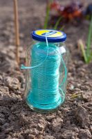 A useful way of keeping gardener's nylon string from getting knotted up is to keep it in a glass jar